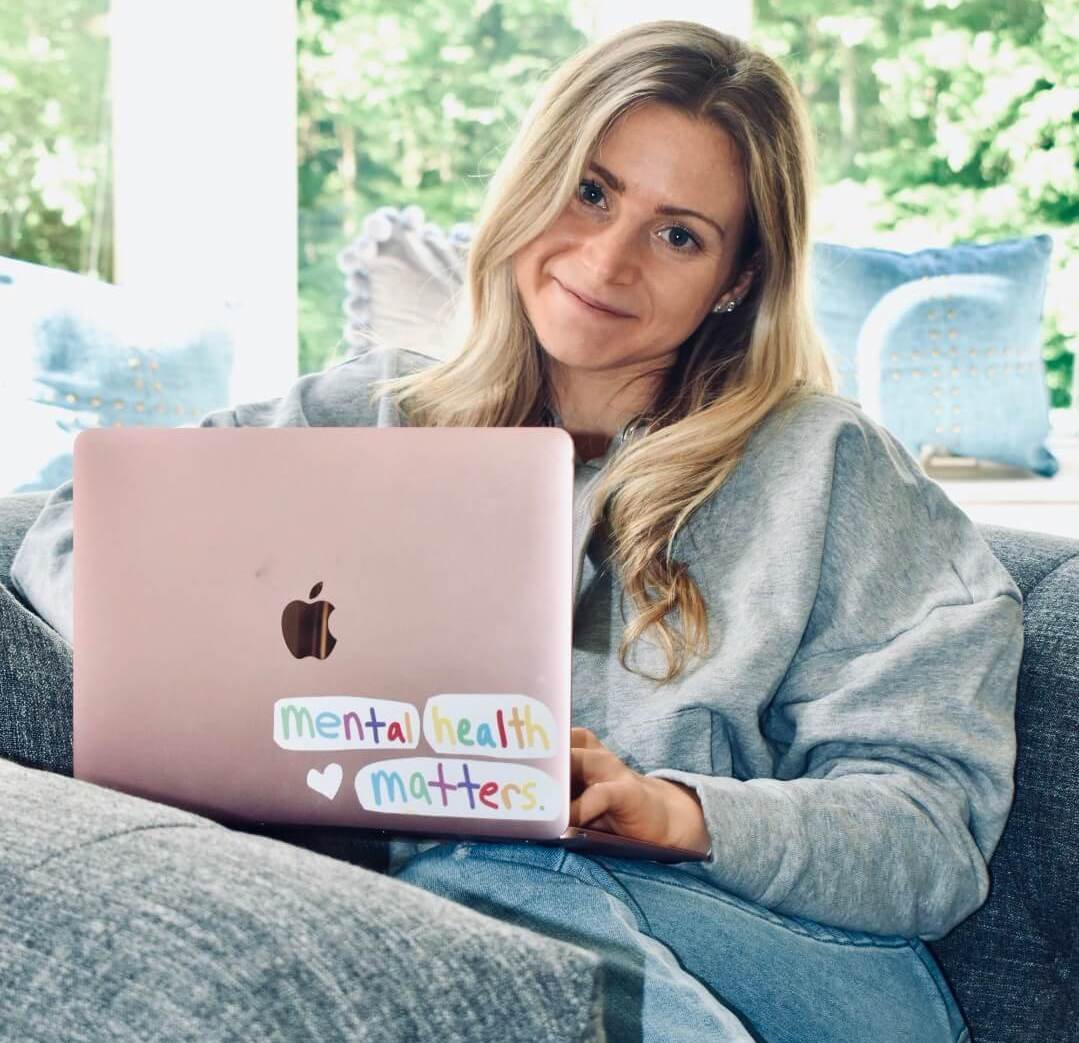 Woman sitting on chair with laptop